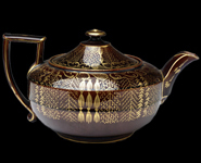 Image of a teapot from the Swinton Pottey decorated with gold gilding.